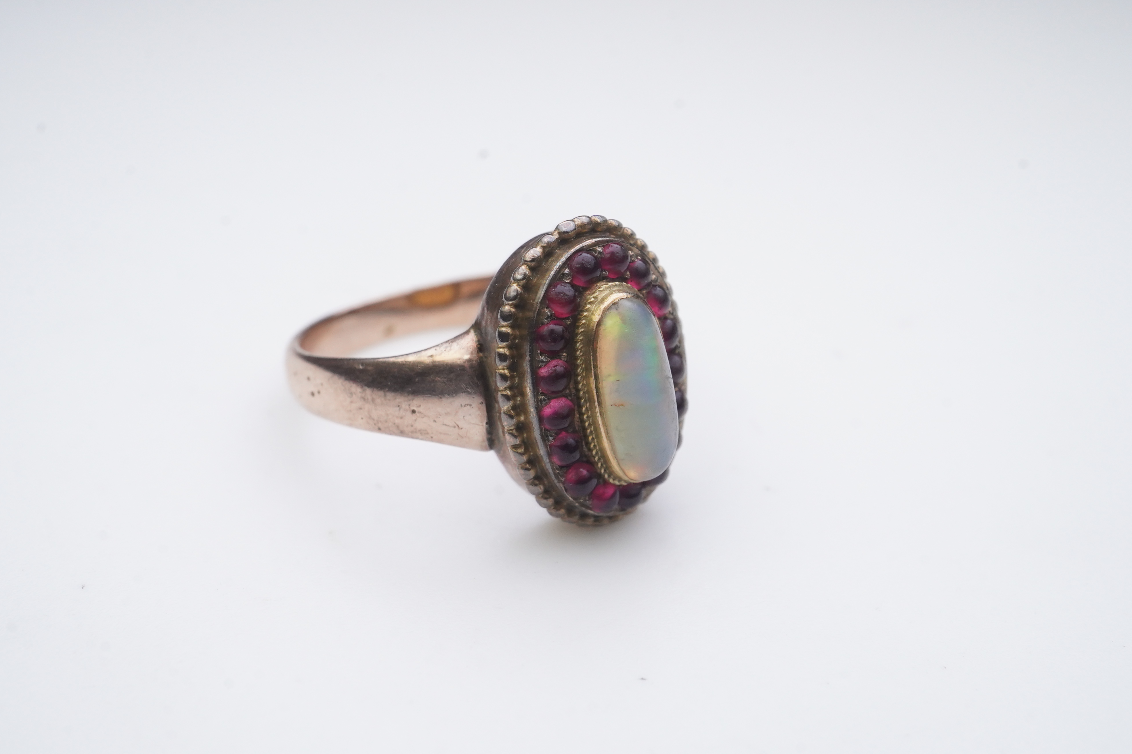 An opal and garnet ring